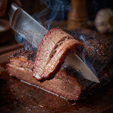 Heavenly Hell The Grilled The Smoked and The Lovely steak & brisket rub 150g — knife slicing a smoked brisket with a smoke ring and mahogany bark